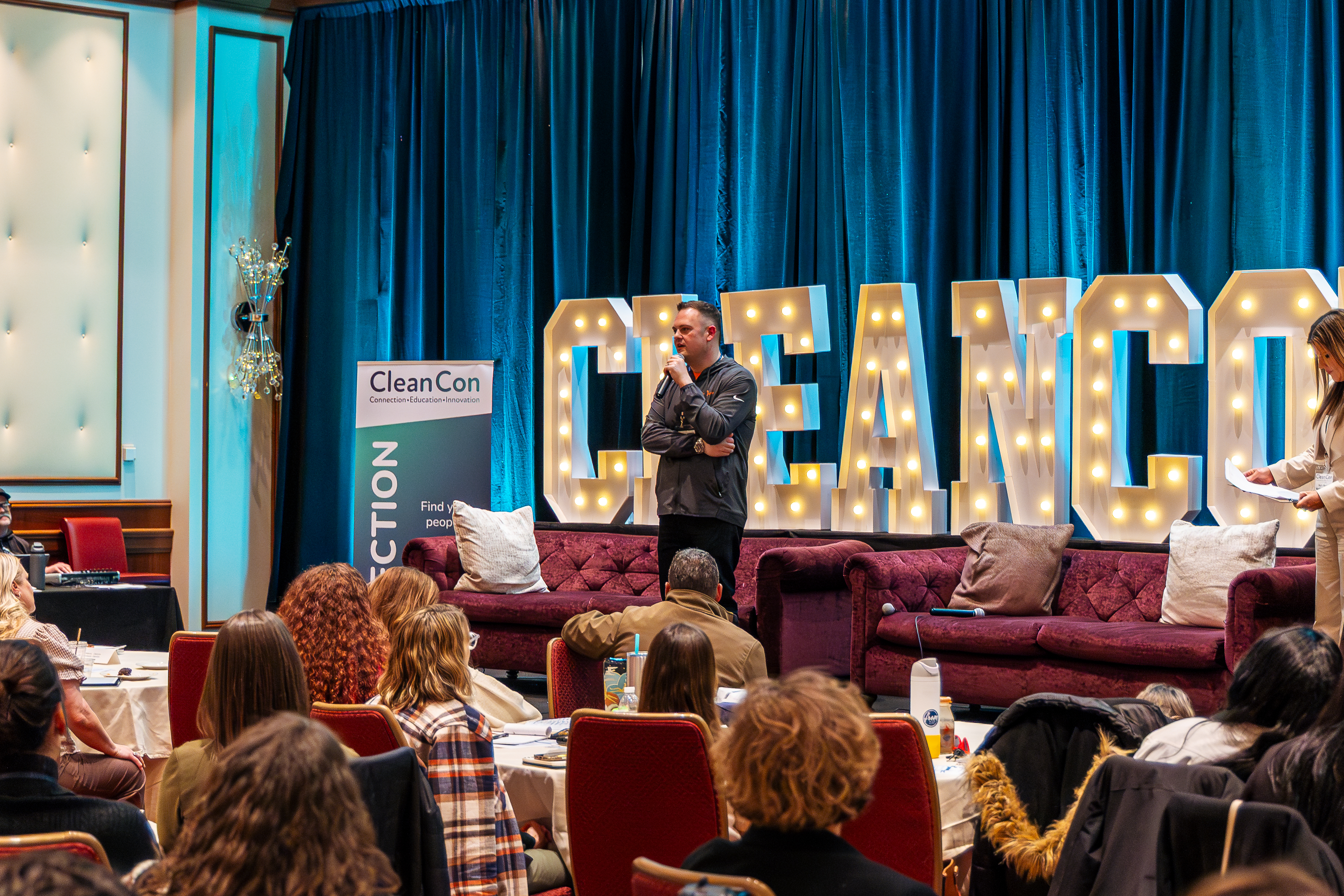 A speaker on the CleanCon stage in front of the audience